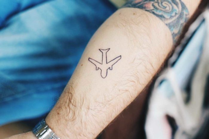 airplane tattoo on a person\'s hand