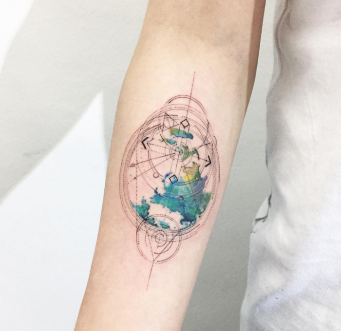compass tattoo on a person\'s hand