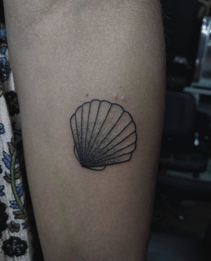 shell tattoo on arm