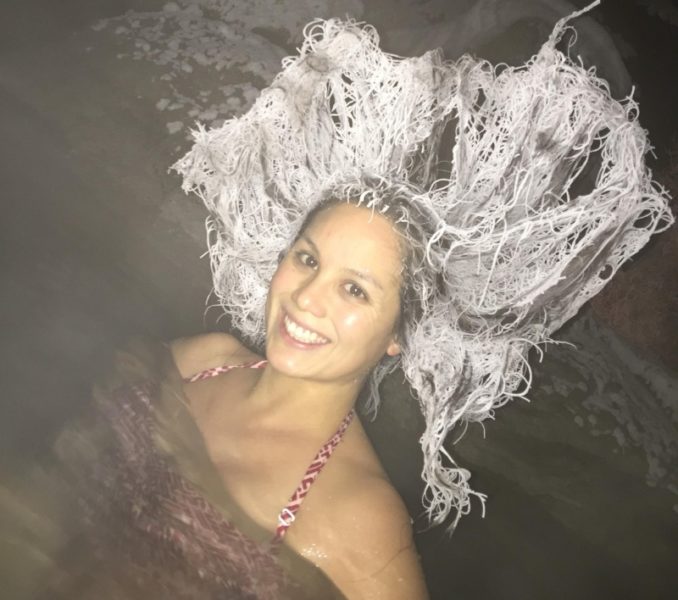 Woman inside hot springs and her hair frozen