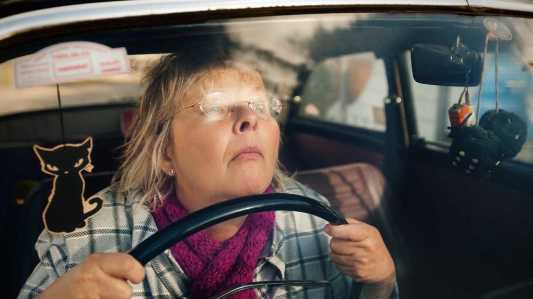 woman with glasses driving