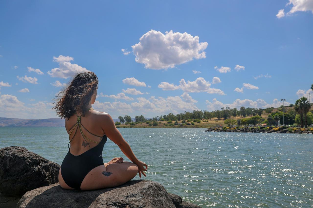 A woman in a swimsuit is looking at the sky